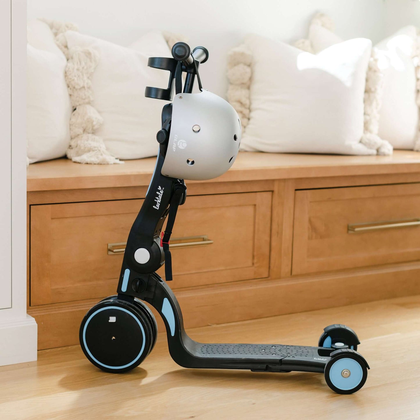 blue Larktale Scoobi with helmet on handlebar next to seat and cushions